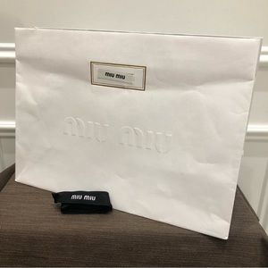 Authentic MIU MIU gift bag with MIU MIU ribbon. Very good condition.